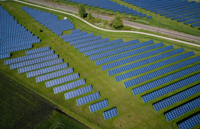 aerial photography of grass field with blue solar panels