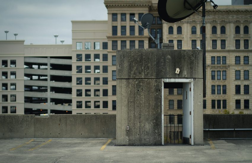 gray concrete house surrounded with buildings